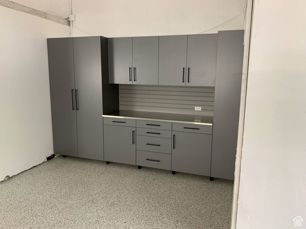 Kitchen with gray cabinetry and dark speckled floor