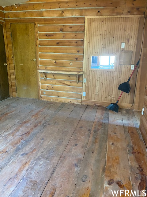 Spare room featuring wood-type flooring
