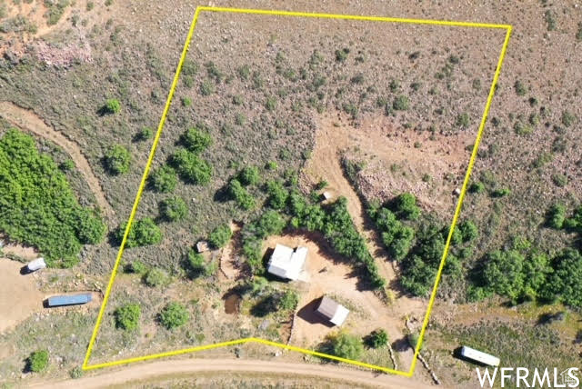 Aerial view of sparsely populated area with property parcel outlined and a desert landscape