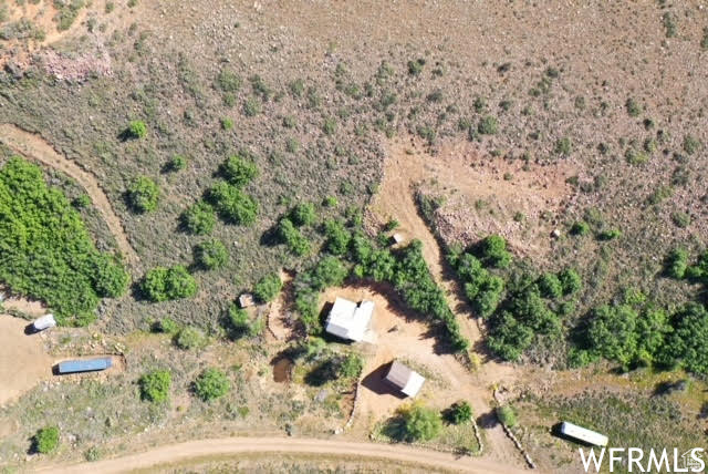 Aerial view of property and surrounding area featuring rural landscape and a desert landscape