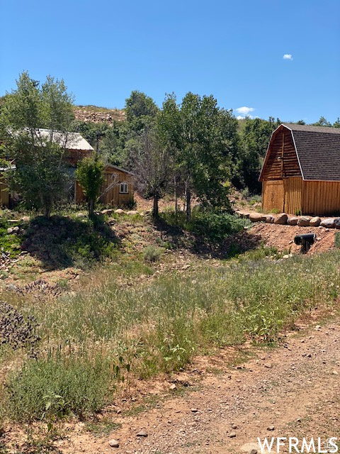 View of yard featuring a barn and an outdoor structure