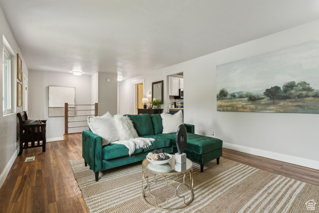 Living room with wood finished floors and baseboards