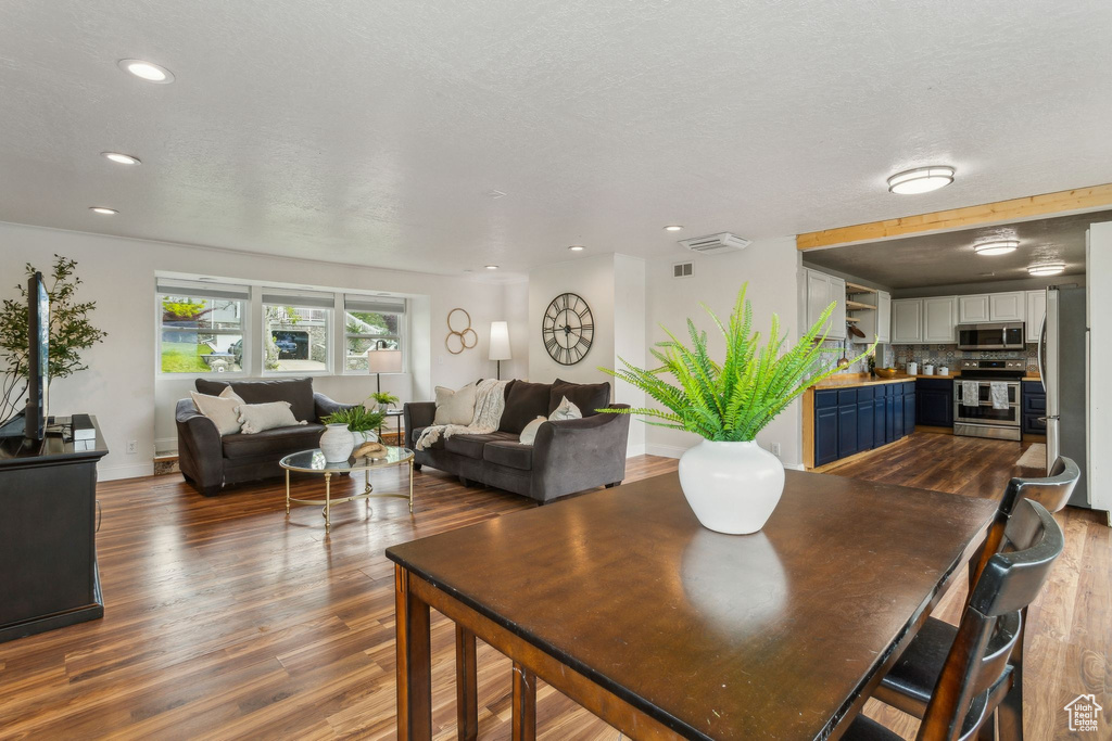 Dining space featuring wood finished floors, baseboards, and recessed lighting