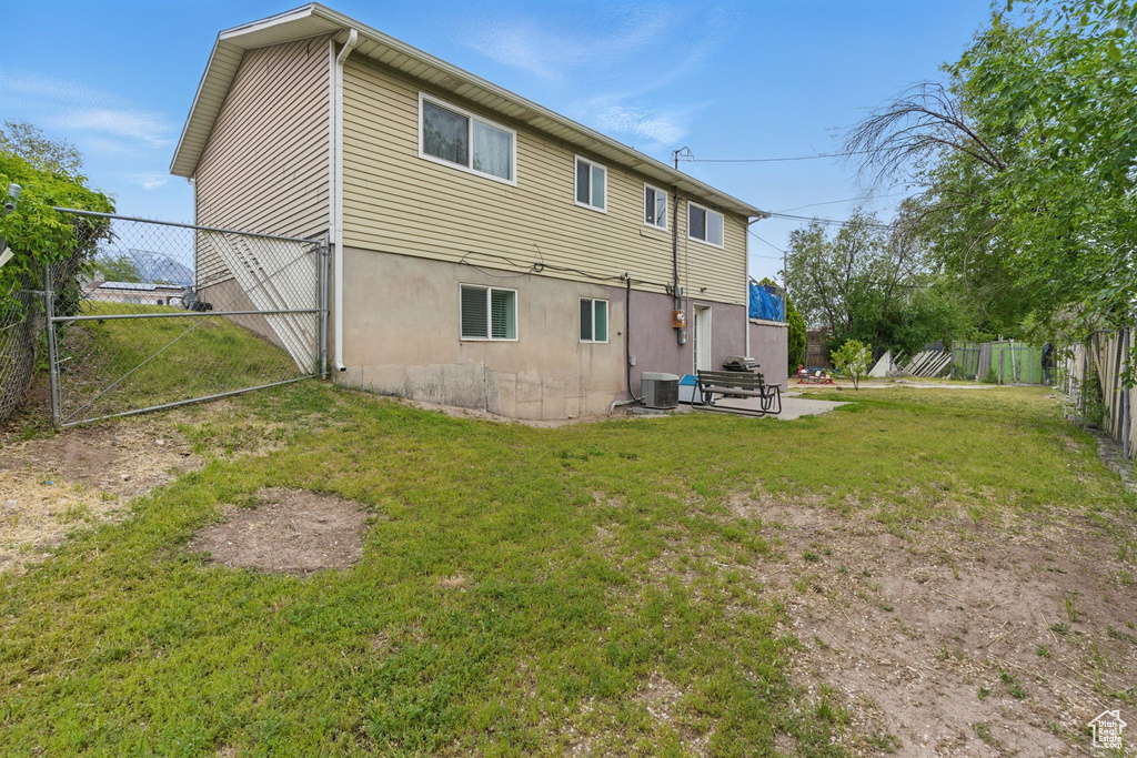 Back of property with a patio and central air condition unit