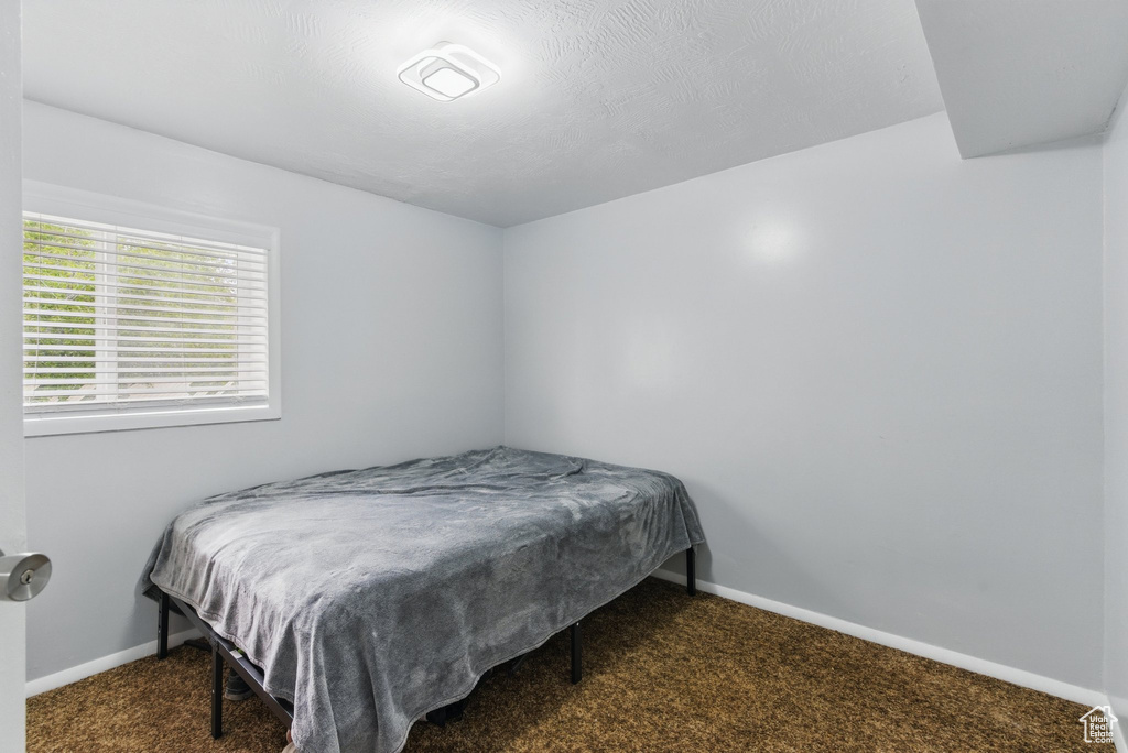 Carpeted bedroom featuring baseboards