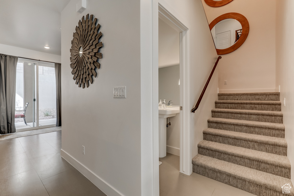 Staircase featuring baseboards and recessed lighting