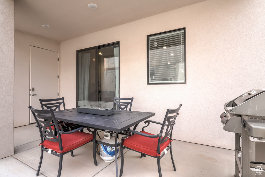 View of patio with outdoor dining area and area for grilling