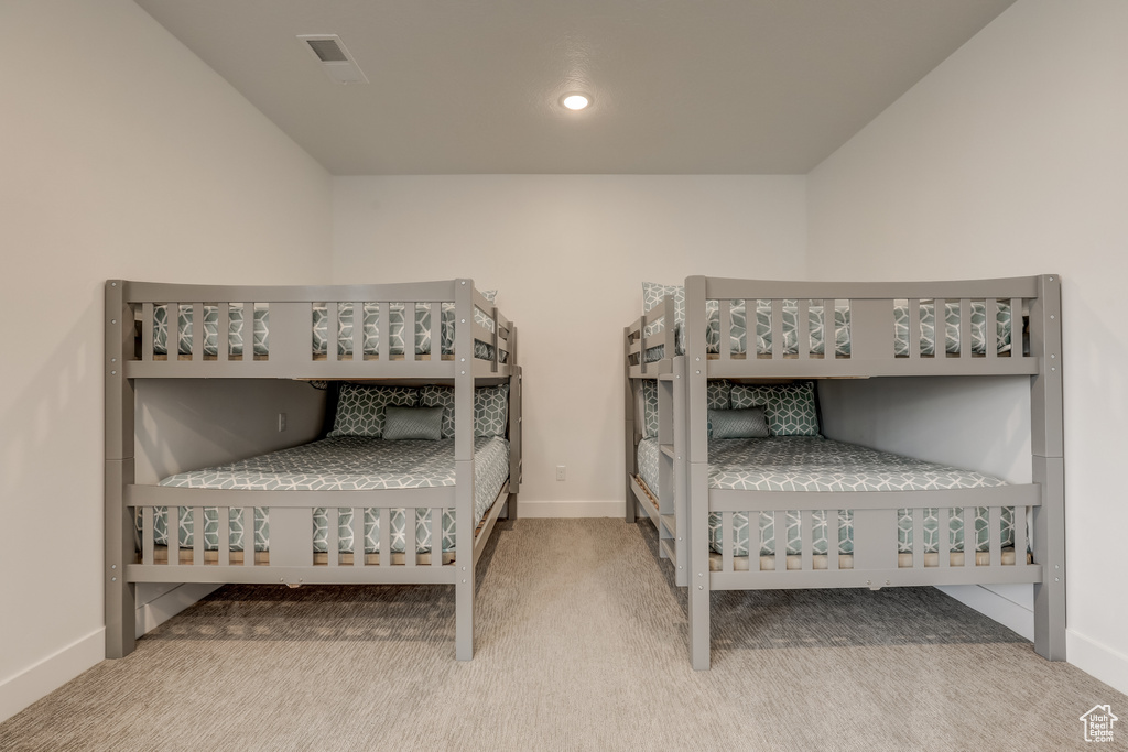 Carpeted bedroom featuring baseboards
