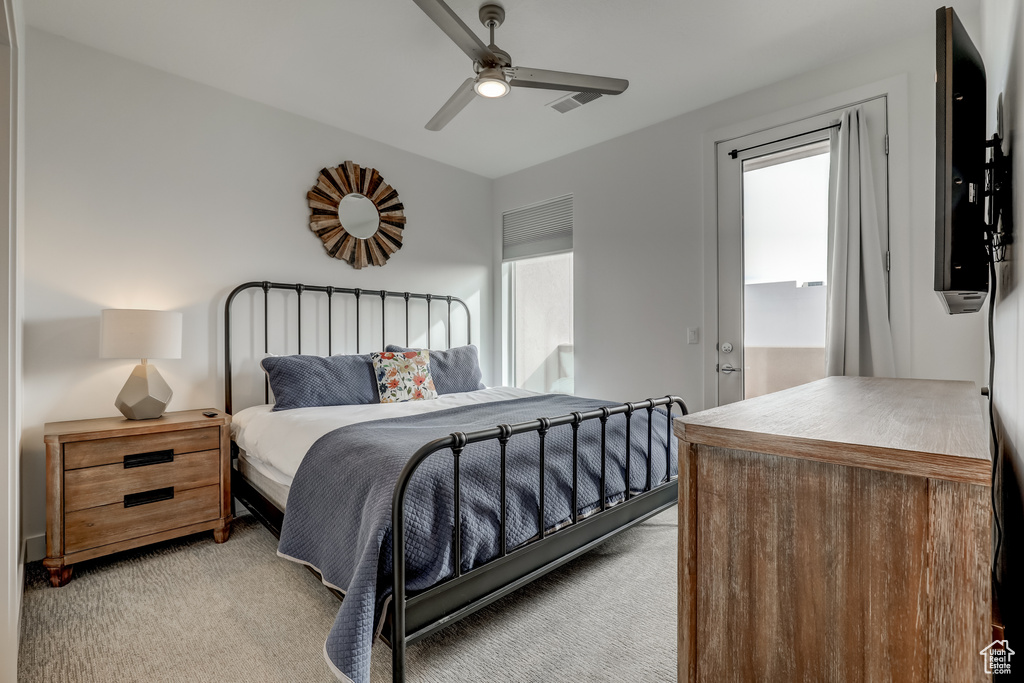 Bedroom featuring light carpet and a ceiling fan