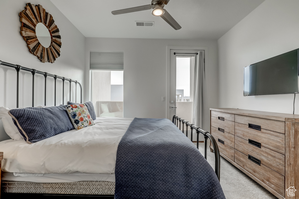 Bedroom featuring light colored carpet and a ceiling fan