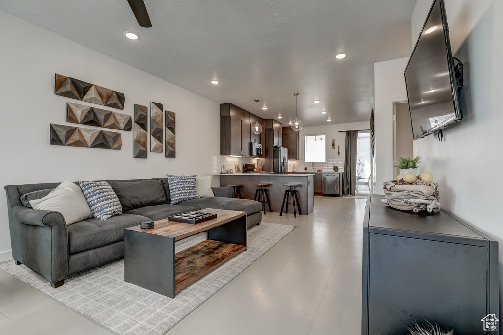 Living area with recessed lighting and ceiling fan