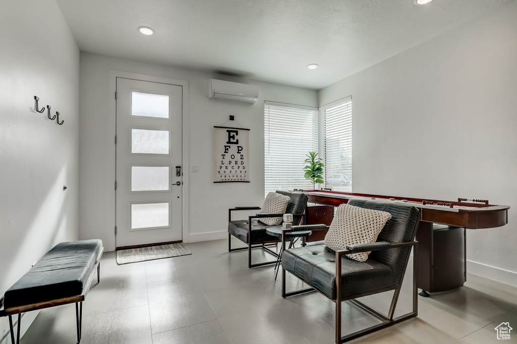Entryway featuring a wall mounted AC, baseboards, and recessed lighting
