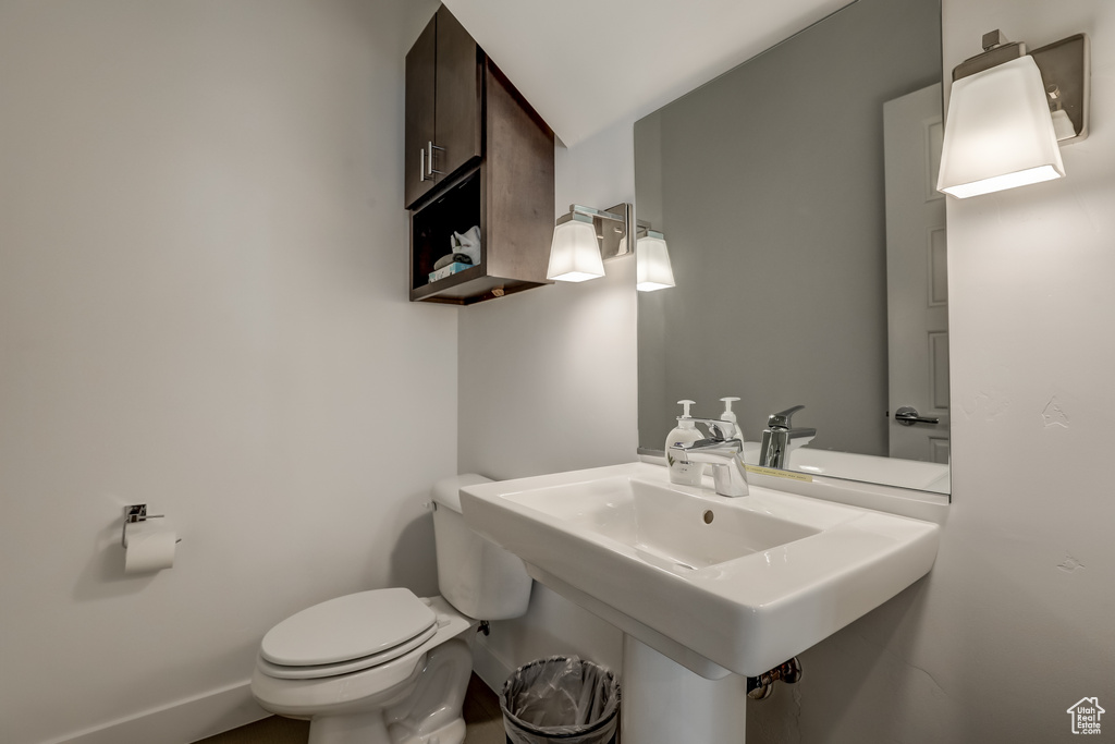 Half bathroom with toilet and a sink