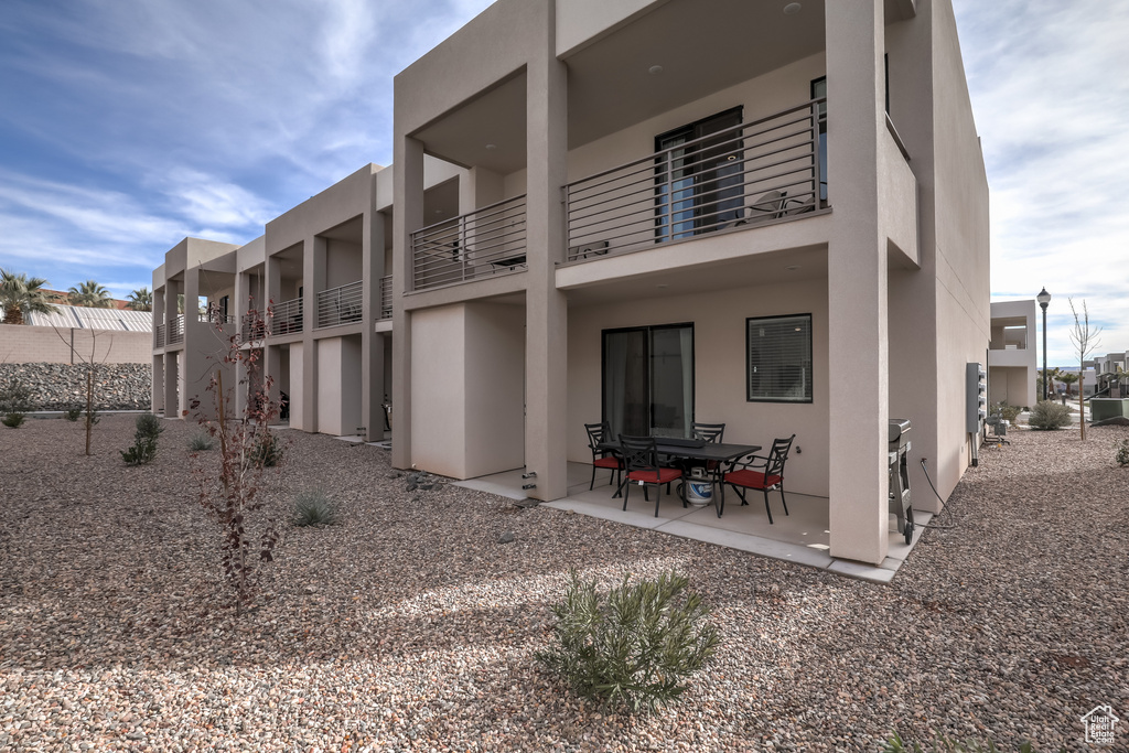 Back of house featuring stucco siding and a patio area