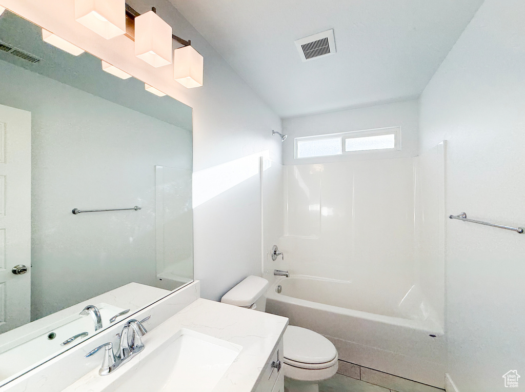 Full bath with toilet, vanity, and shower / bathtub combination