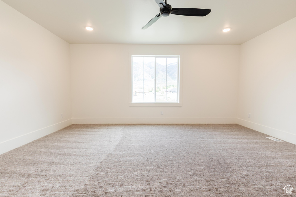 Spare room with ceiling fan, baseboards, carpet, and recessed lighting