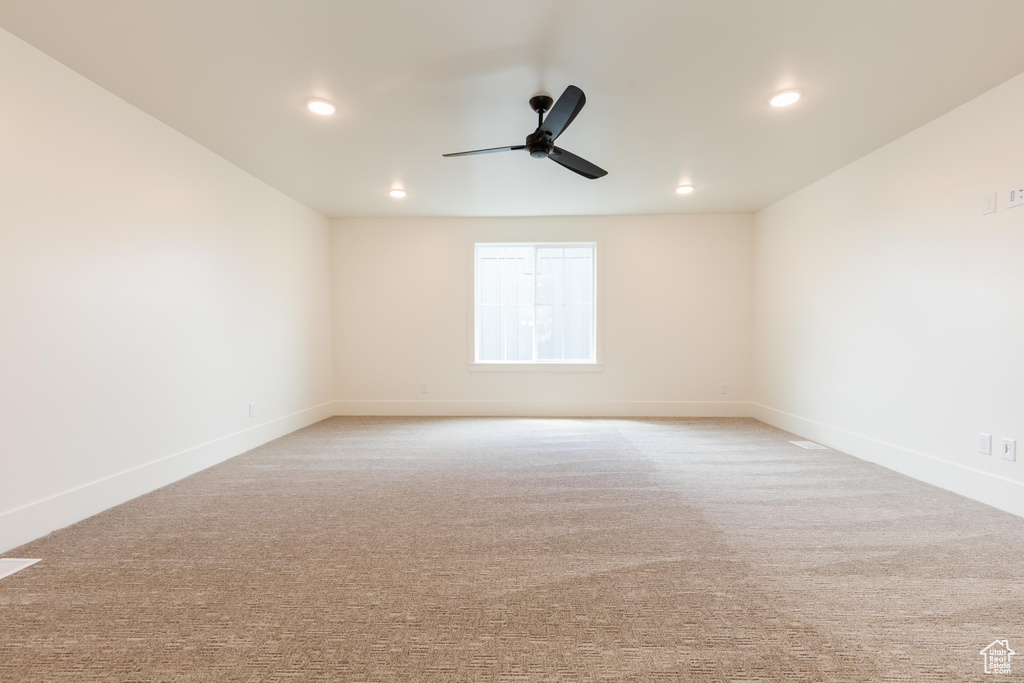 Carpeted spare room with ceiling fan, recessed lighting, and baseboards