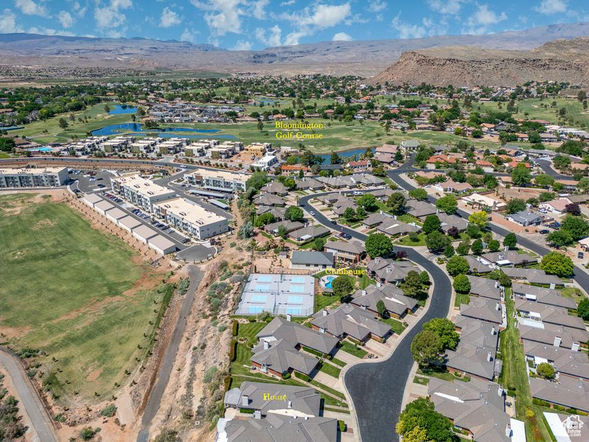 Aerial view of property's location with a water and mountain view and nearby suburban area