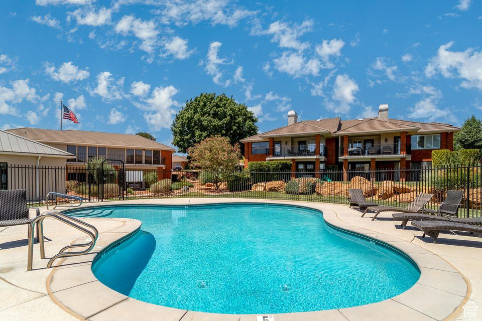 Community pool with fence and a patio