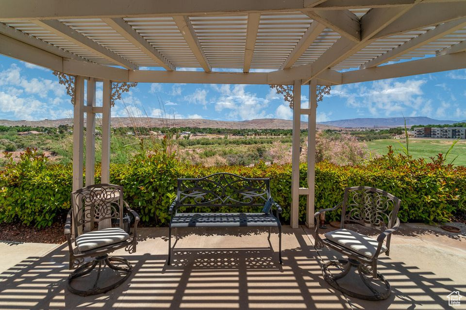 View of patio with a mountain view and a pergola