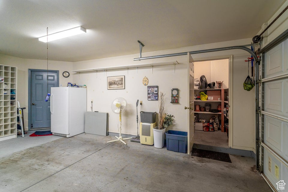 Garage featuring freestanding refrigerator