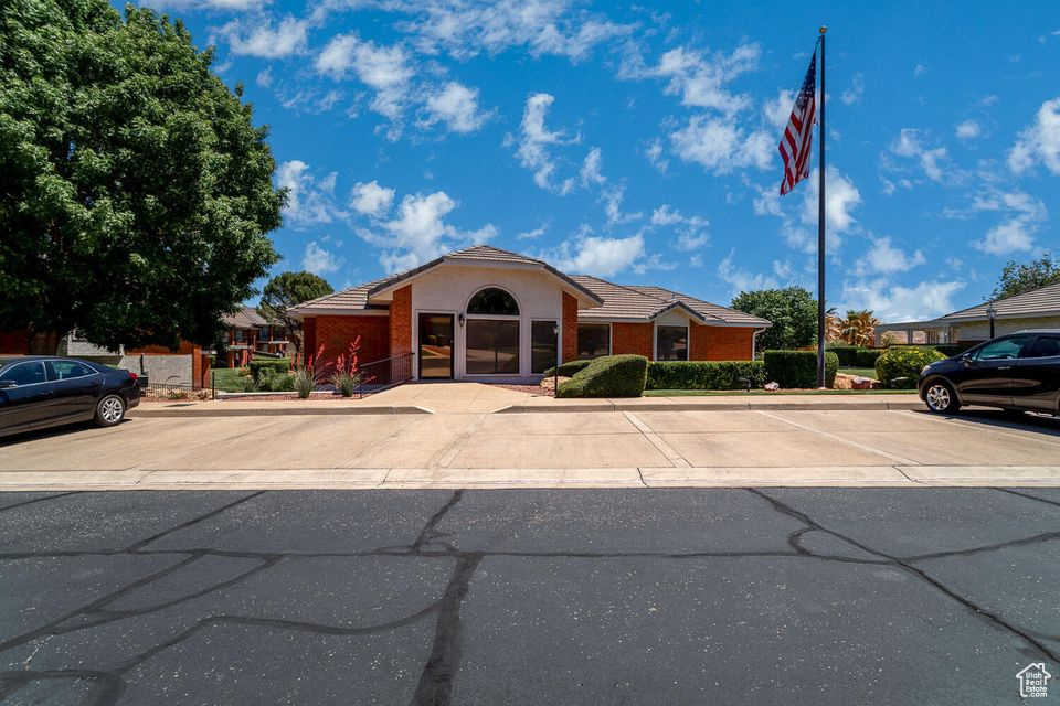 Ranch-style house featuring uncovered parking and a tiled roof