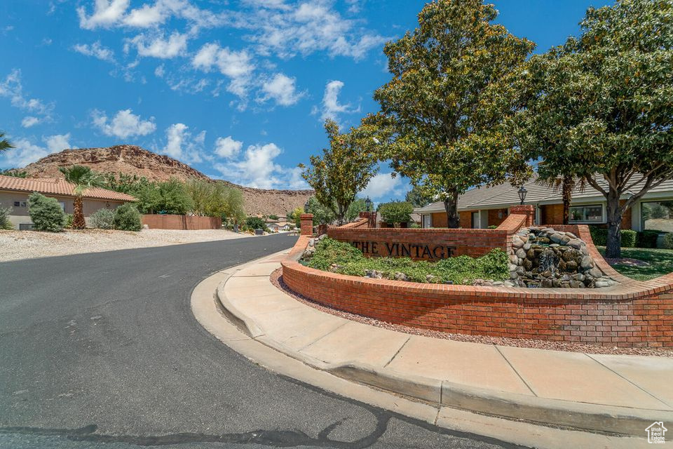 View of asphalt street with a mountain view, curbs, and sidewalks