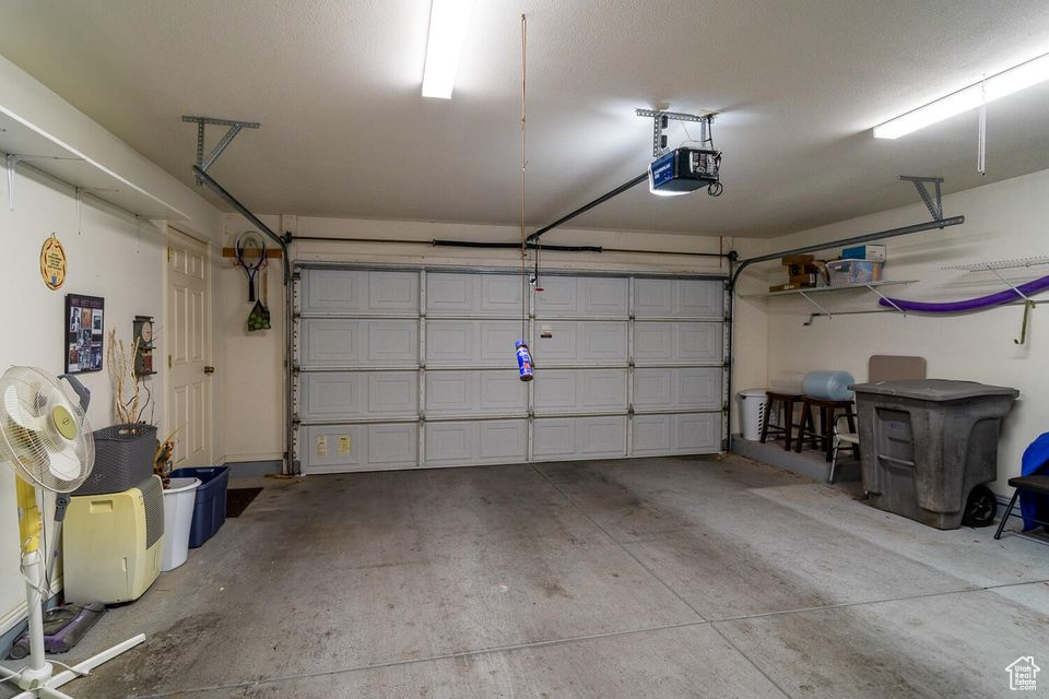 Garage featuring a garage door opener