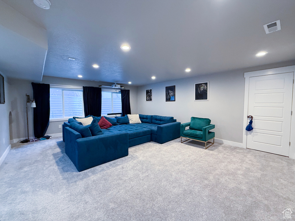 Carpeted living area featuring baseboards and recessed lighting