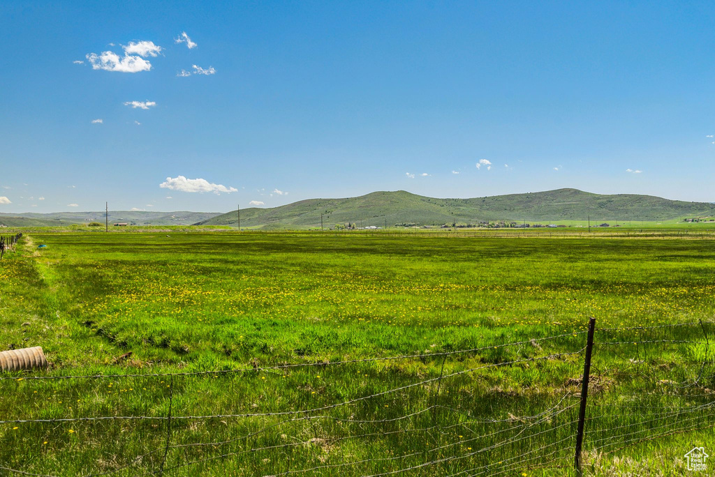 View of mountain backdrop with rural landscape and a pastoral area