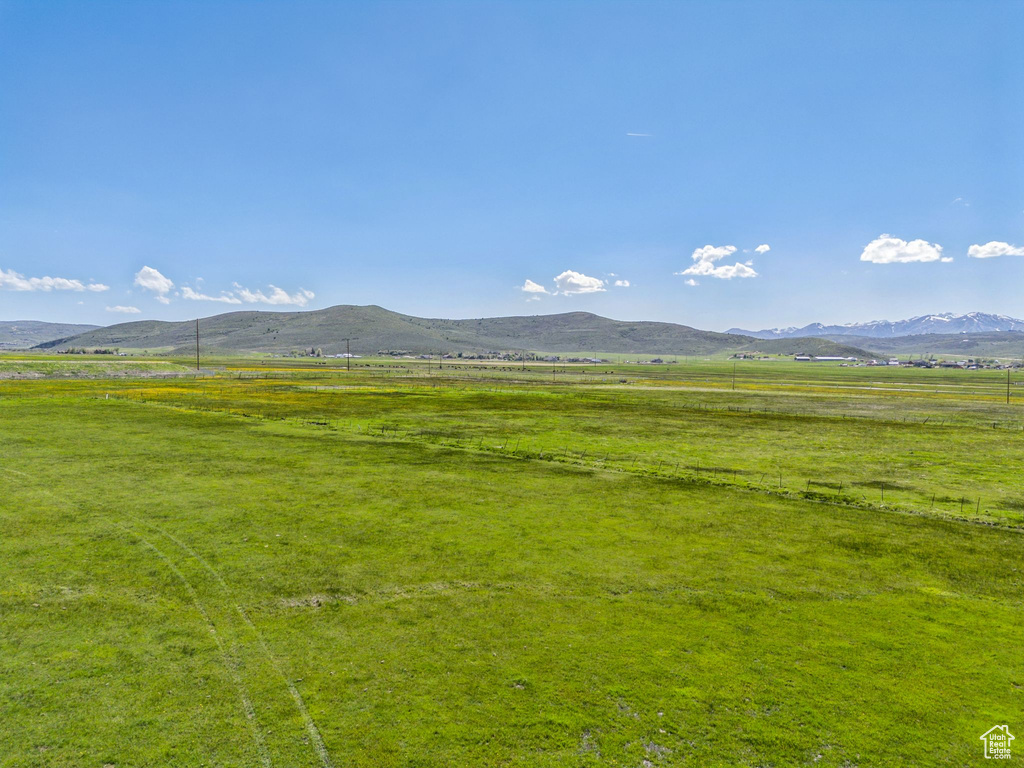 View of mountain backdrop with rural landscape and agricultural land