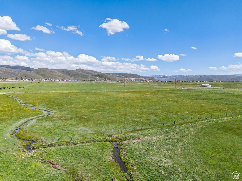 View of mountain backdrop with rural landscape and agricultural land