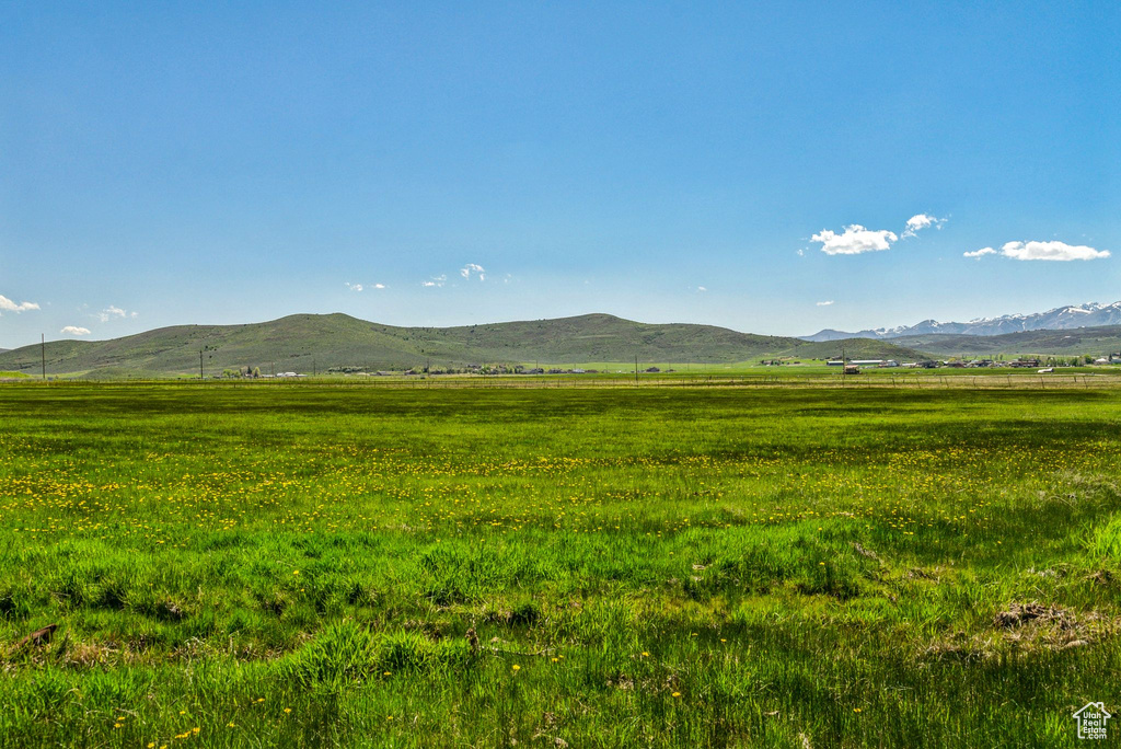 View of mountain backdrop featuring rural landscape and agricultural land