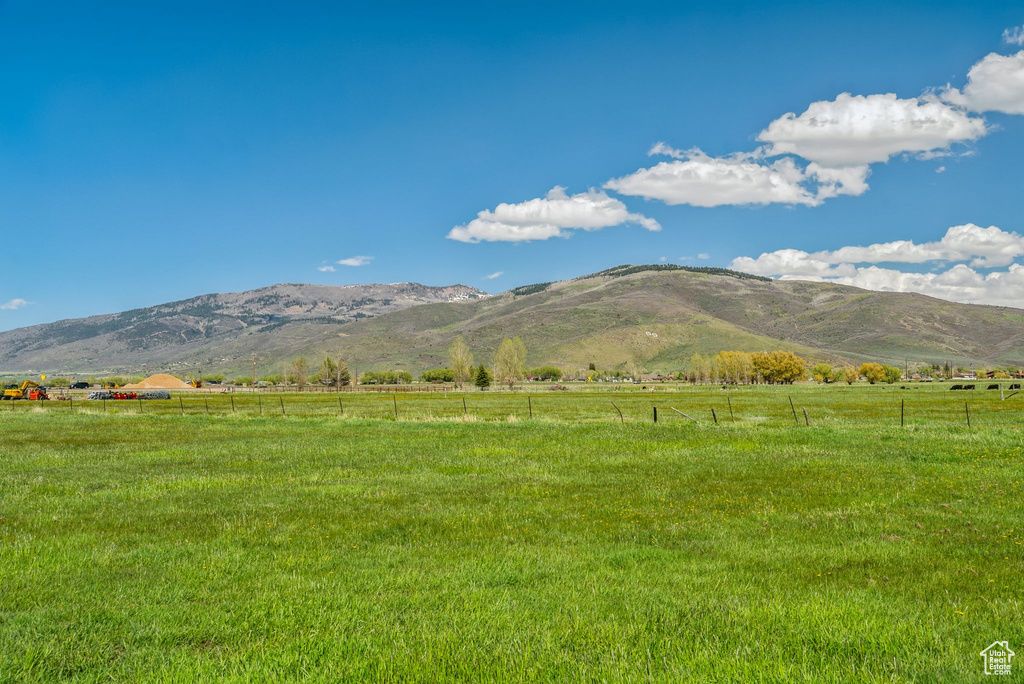 View of mountain backdrop with rural landscape and agricultural land