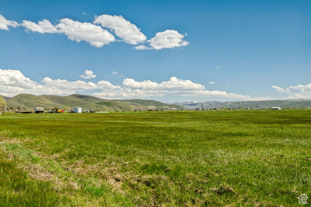 View of mountain backdrop with rural landscape and agricultural land