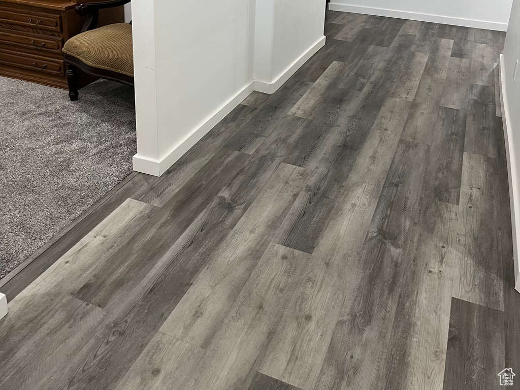 Detailed view of baseboards and wood finished floors