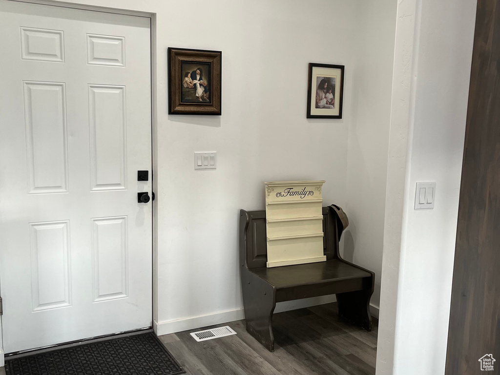 Entrance foyer with baseboards and dark wood-style flooring