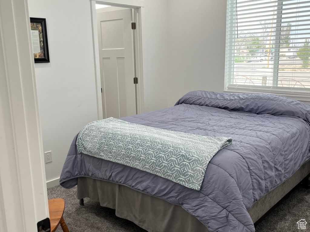 Bedroom featuring carpet floors and baseboards
