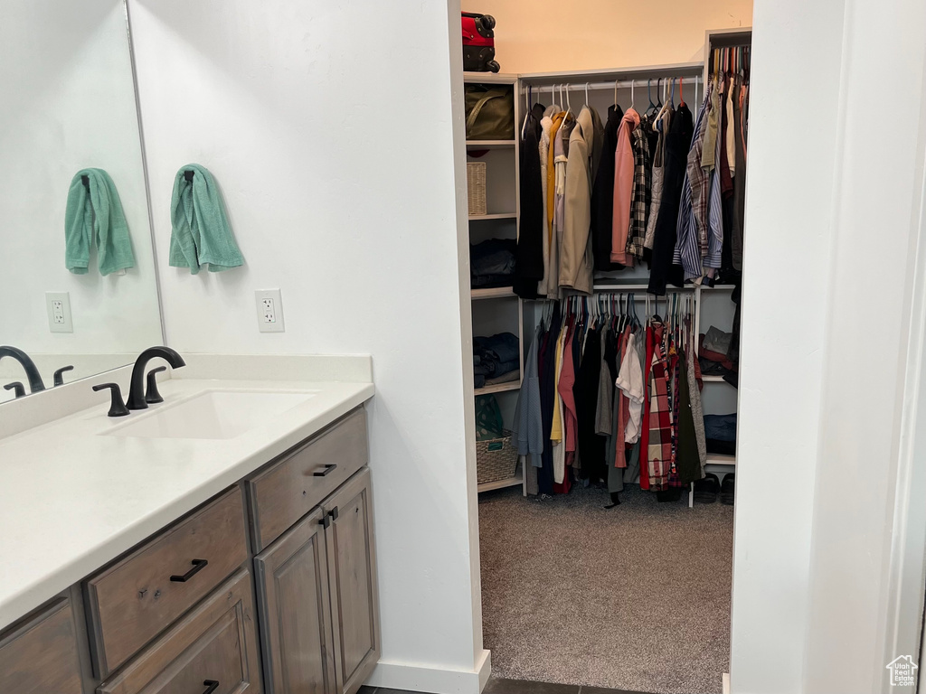 Bathroom featuring a spacious closet and vanity