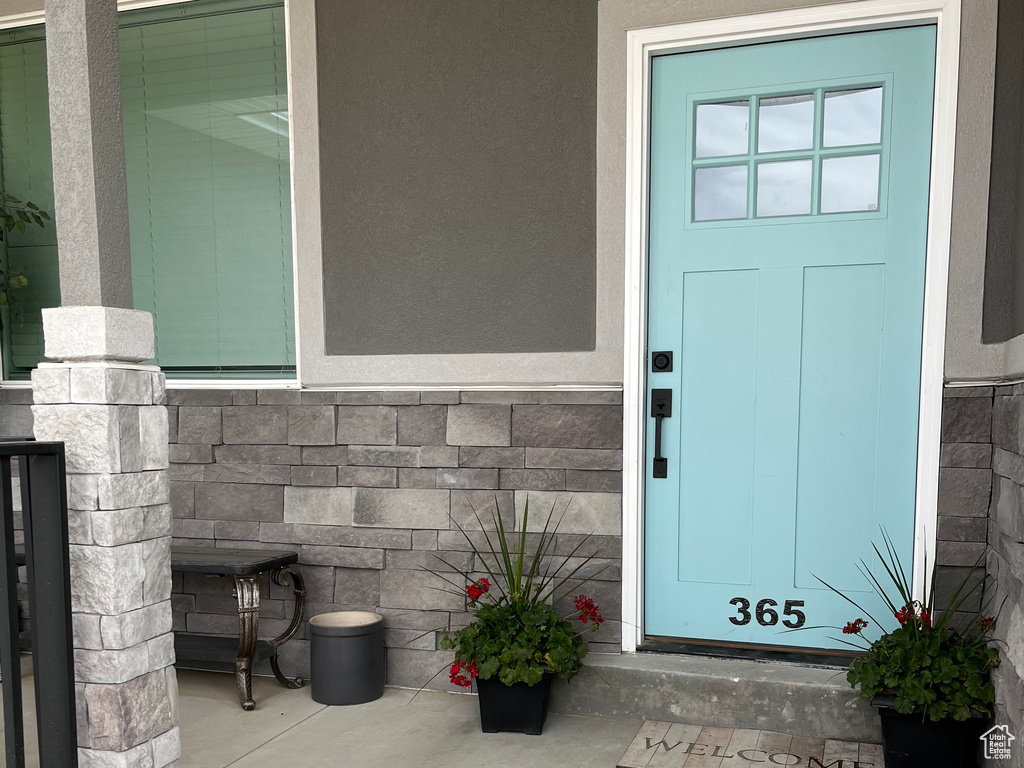 View of exterior entry featuring stone siding