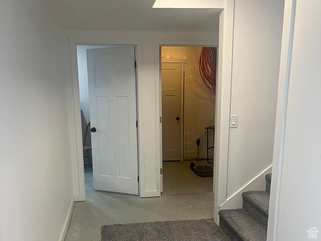 Hallway featuring baseboards and stairway