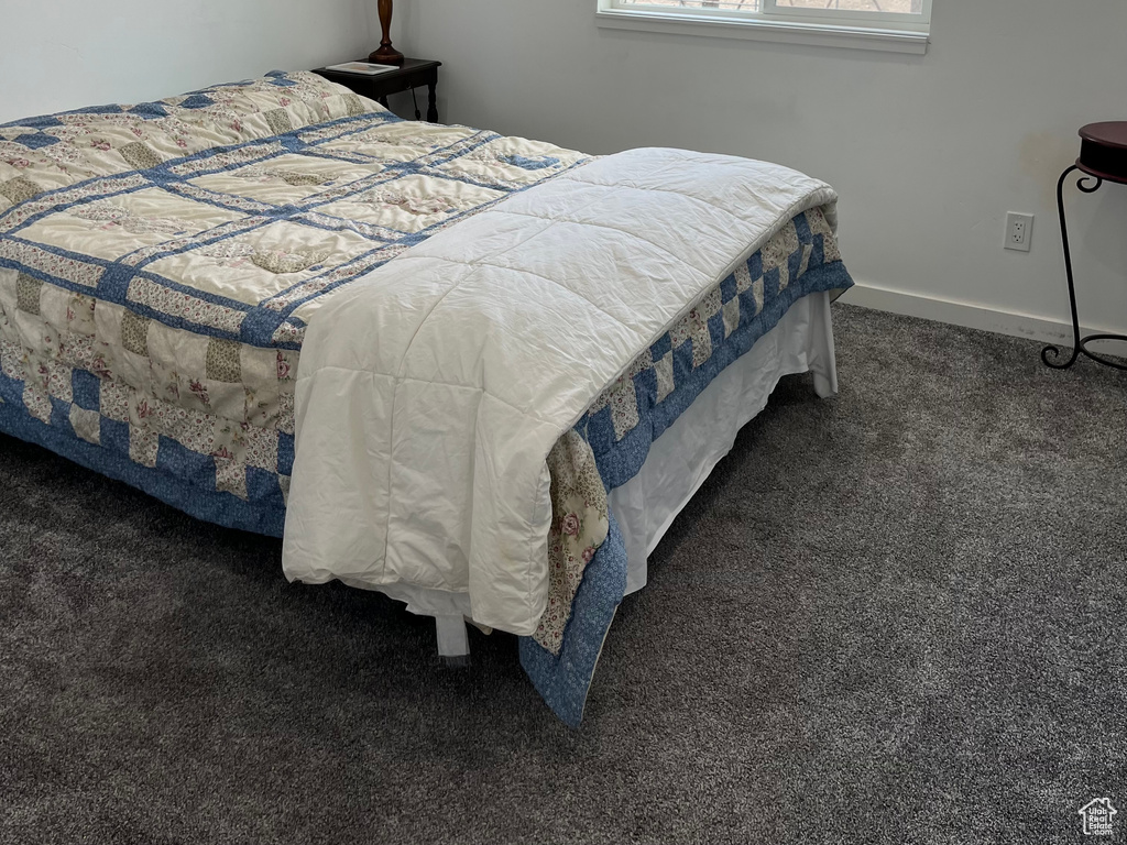 Carpeted bedroom featuring baseboards
