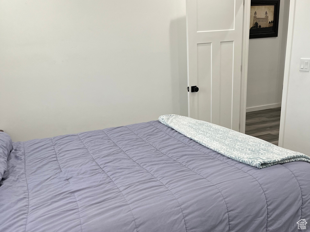 Bedroom featuring wood finished floors and baseboards