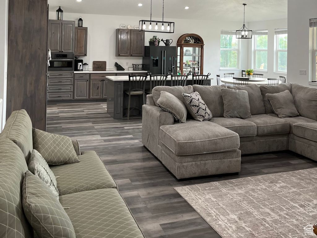 Living area featuring recessed lighting, dark wood finished floors, and a chandelier