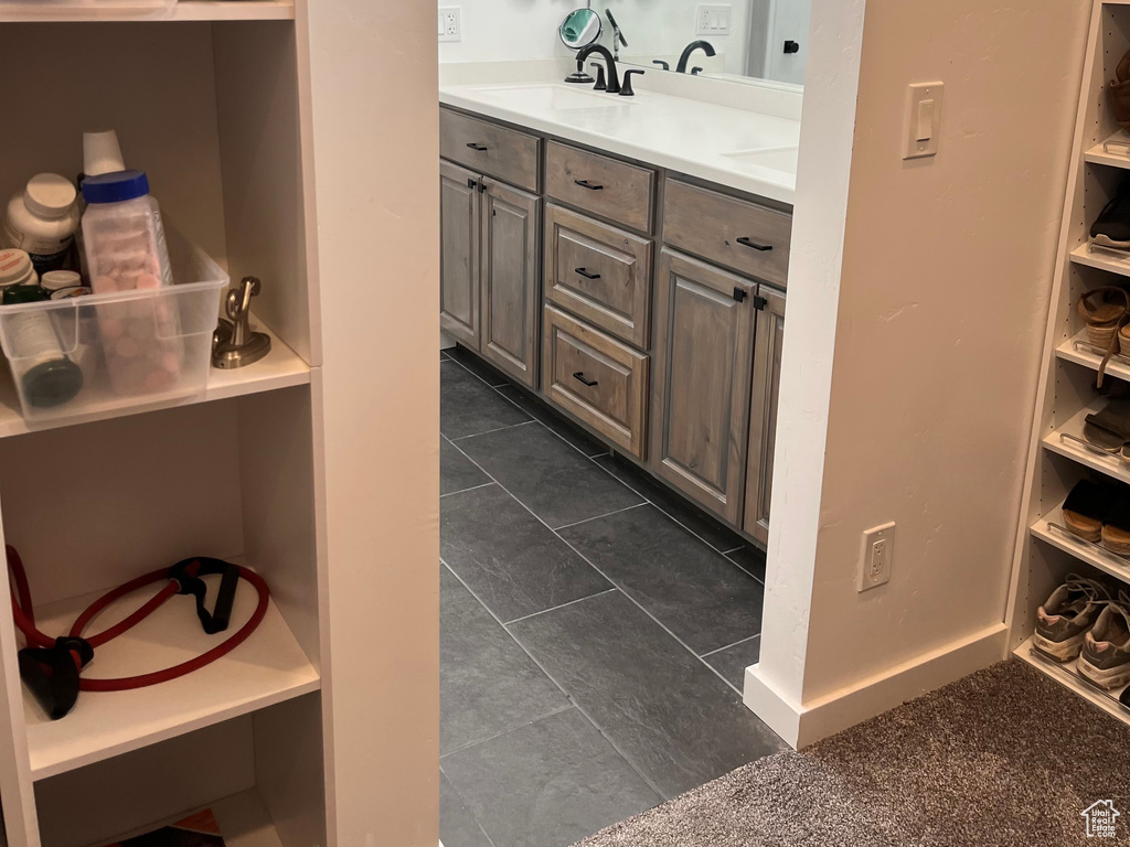 Bathroom with double vanity and tile patterned floors