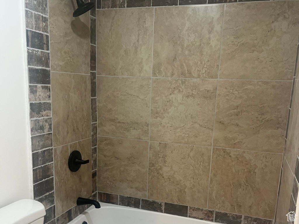 Bathroom view of toilet and  shower combination