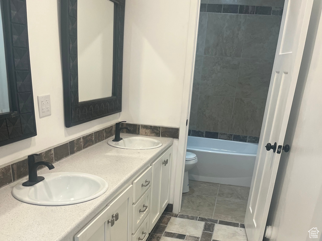 Bathroom featuring toilet and double vanity