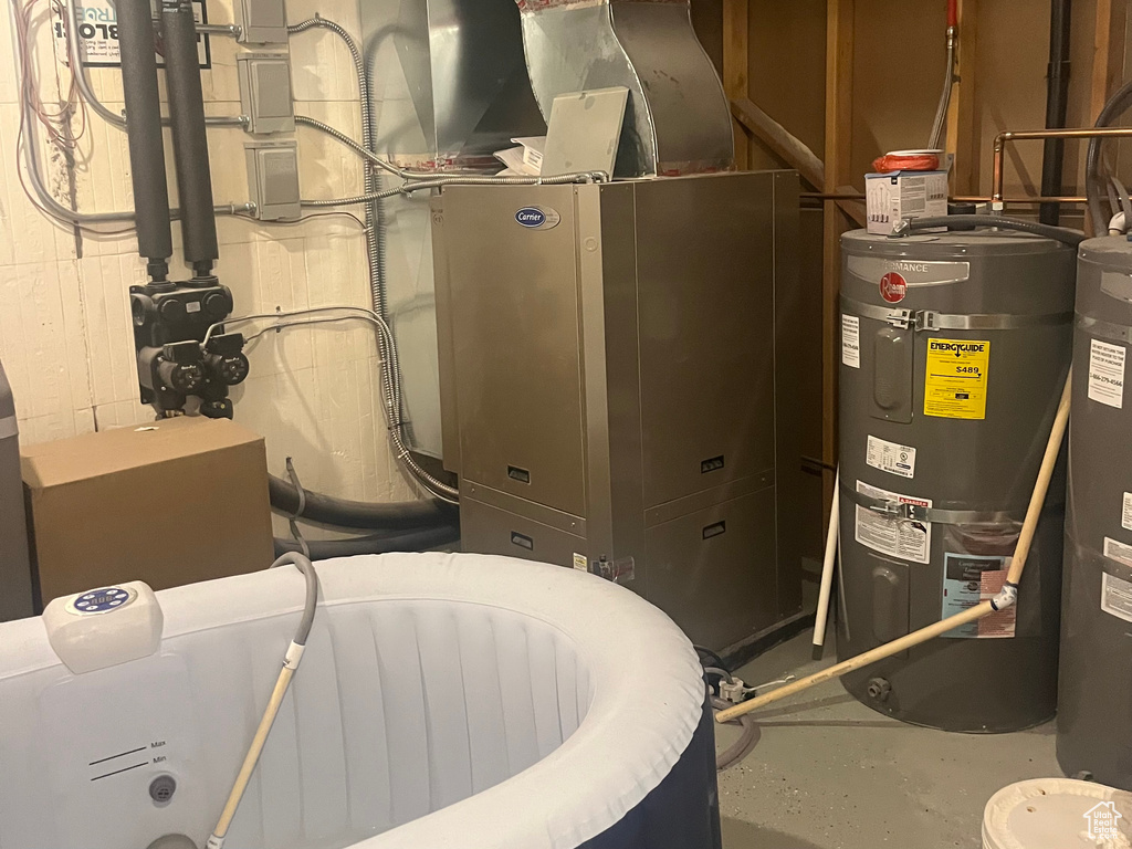Utility room with electric water heater and water heater