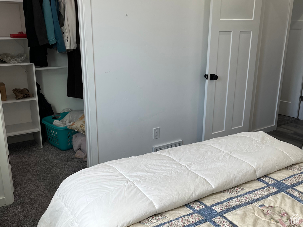 Carpeted bedroom with a closet