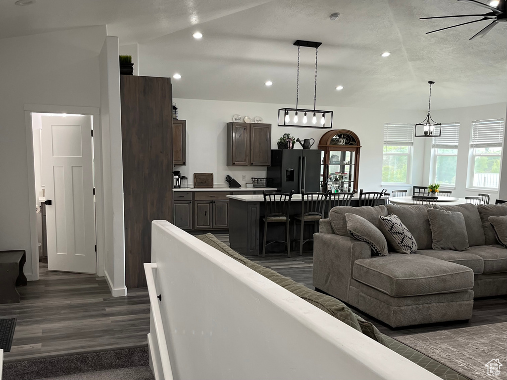 Living room with recessed lighting, ceiling fan, and dark wood-style floors